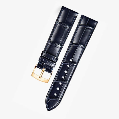 Dark blue alligator-textured leather strap with rose gold buckle, compatible with Omega Constellation models. Elegant texture and refined craftsmanship by WatchesMate