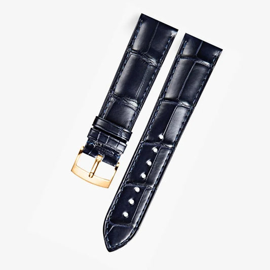 Dark blue alligator-textured leather strap with rose gold buckle, compatible with Omega Constellation models. Elegant texture and refined craftsmanship by WatchesMate