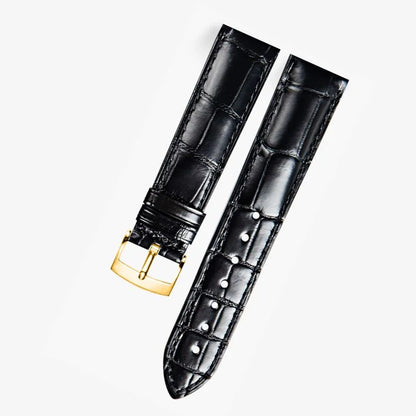 Black alligator-textured leather watch band compatible with Omega dress watches, featuring a polished gold pin buckle for a refined and timeless look