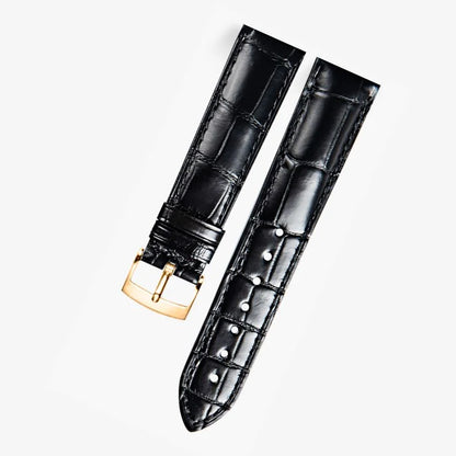 Black alligator-textured leather watch band compatible with Omega dress watches, featuring a polished rose gold pin buckle for a refined and timeless look